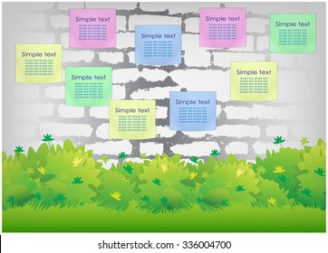 Stickers and hedge on brick wall