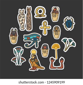 Stickers Set of Ancient Egyptian sacred and cultural symbols including mummyfied cats, eye of horus, scarab, canopic jars; ka; ba; floral decoration elements. Isolated vector illustrations.