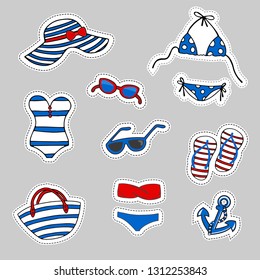 Stickers set. Striped blue, white and red beach accessories in a marine style. Female summer bikini swimsuit, hat, bag, sunglasses, flip flops, on grey background