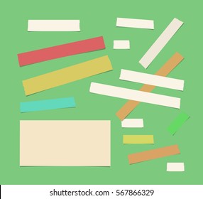 Sticky, adhesive masking tape, ruled paper stuck on green background