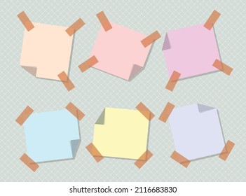 Sticky notes in different colors with tape on a plaid background 