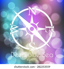 Stock blurred texture with bokeh effect and stylized compass