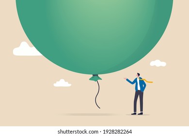 Stock market, crypto currency bitcoin bubble, risk of speculation investment, big debt balloon ready to burst concept, fearful businessman investor standing under huge big air balloon bubble.