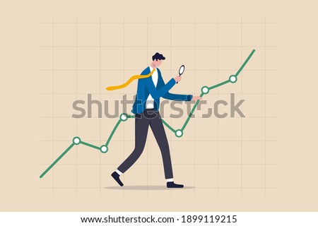 Stock market data analysis, financial research professional or investment and economic forecast concept, smart businessman analyst using magnifying glass look in details on market data rising graph.