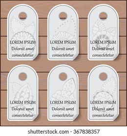 stock vector set of label with floral pattern on the wood background. template