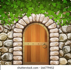 Stone wall with arched medieval wooden door and leaves