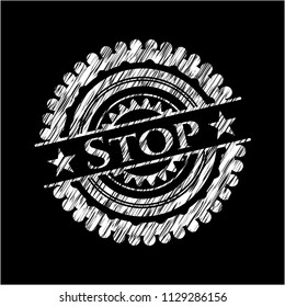 Stop chalk emblem written on a blackboard