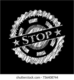 Stop chalk emblem written on a blackboard