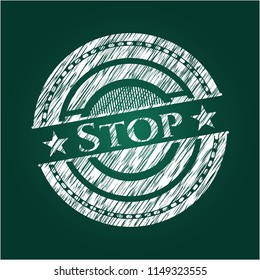 Stop chalkboard emblem written on a blackboard