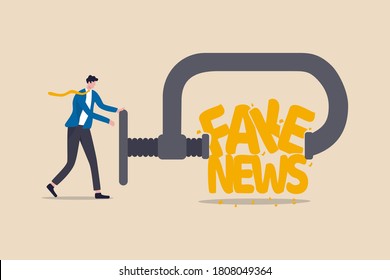 Stop Fake News And Misinformation Spreading On Internet And Media Concept, Businessman Leader Squeezing And Destroy The Word Fake News.