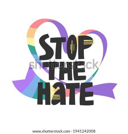 Stop the hate lettering on a rainbow colored heart-shaped ribbon