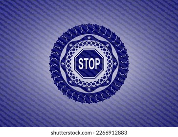 stop icon inside badge with denim background. 