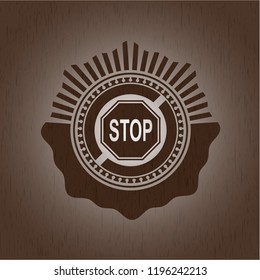 stop icon inside badge with wooden background