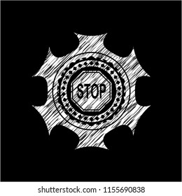 stop icon inside chalk emblem written on a blackboard