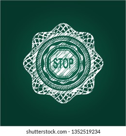 stop icon inside chalk emblem written on a blackboard