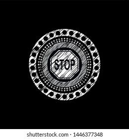 stop icon inside chalk emblem written on a blackboard