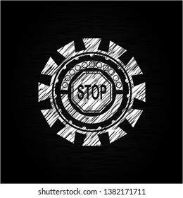 stop icon inside chalkboard emblem written on a blackboard