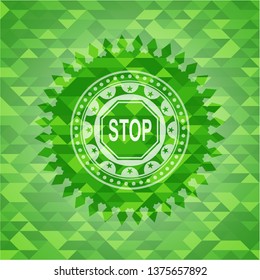 stop icon inside green emblem with mosaic background