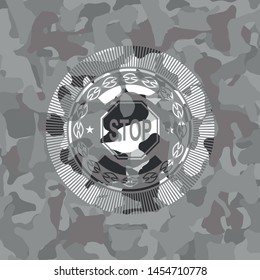 stop icon inside grey camouflage emblem