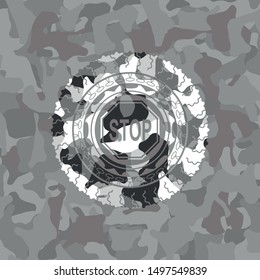 stop icon inside grey camouflage emblem