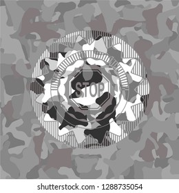 stop icon inside grey camouflaged emblem
