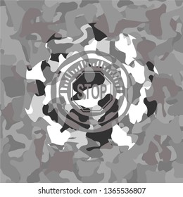 stop icon inside grey camouflaged emblem