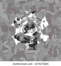 stop icon inside grey camouflaged emblem