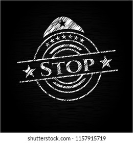 Stop written on a blackboard