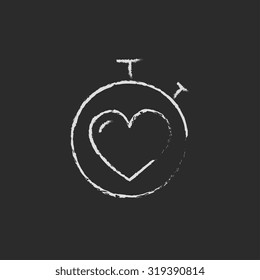 Stopwatch with heart hand drawn in chalk on a blackboard vector white icon isolated on a black background.