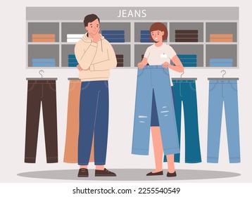 Store seller showing a jeans to man customer. Shop assisting helping shopper in  jeans store.
