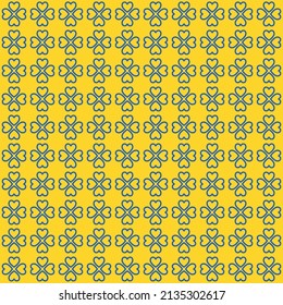 St.Patrick's Day. Blue clover leaves on yellow background pattern. Blue heart shape pattern on yellow backdrop.