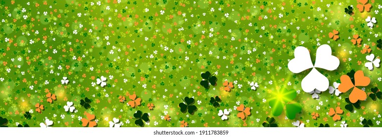 St.Patrick's Day green blurred vector background with colorful clover leaves