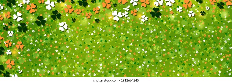 St.Patrick's Day green blurred vector background with colorful clover leaves
