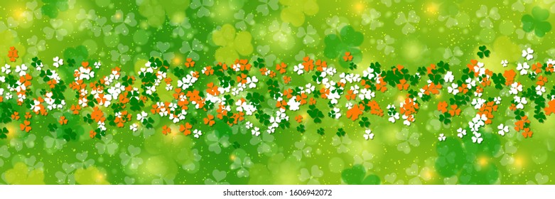 St.Patrick's Day vector banner. Green blurred background with clover leaves and light effects