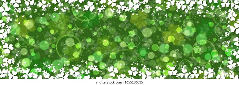 St.Patrick's Day vector banner template. Green blurred background with clover leaves and bokeh effect