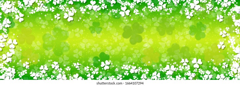 St.Patrick's Day vector banner template. Green blurred background with clover leaves and bokeh effect
