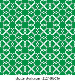 St.Patrick's Day. White clover leaves on green background pattern. White heart shape pattern on green backdrop.