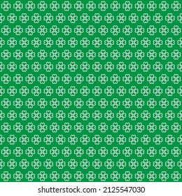 St.Patrick's Day. White clover leaves on green background pattern. White heart shape pattern on green backdrop.