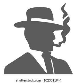 A stranger in a hat holds a smoking cigarette in his hand. Mafia style