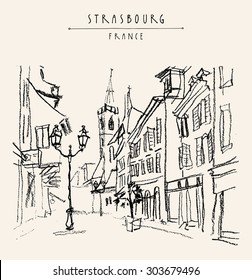 Strasbourg, France. Street in old town. Historical buildings, church, shops, lights. Bold freehand drawing. Black charcoal on paper. Vector travel sketchy postcard, "Strasbourg, France" hand lettering