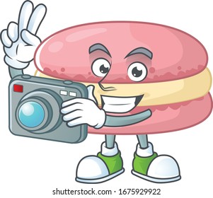 Strawberry macarons mascot design as a professional photographer with a camera