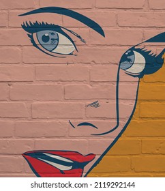 Street art, extreme close-up of a woman's face with gray eyes and red lips on a yellow background.