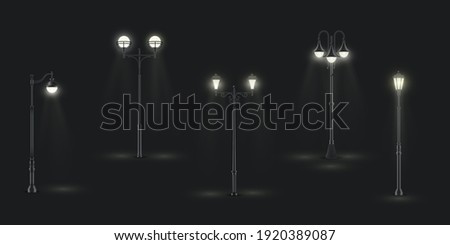 Street lights with one, two, three lamps glowing in night dark. Lanterns on poles outdoor urban various design realistic collection. Illumination equipment. Vector set street lights on black.