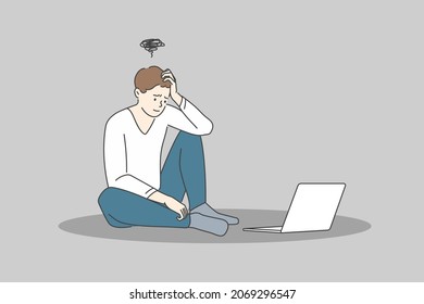 Stress and exhaustion at ideas concept. Young stressed man cartoon character sitting on floor near laptop and feeling frustrated and stuck with ideas vector illustration 