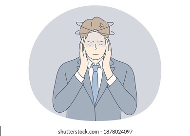 Stress, overwork, overload concept. Unhappy depressed stressed young businessman office worker touching head with fingers, feeling headache, stressed and tired in office. Exhaustion, depression 