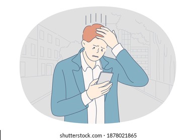 Stress, overwork, problems concept. Unhappy depressed stressed young businessman office worker touching head with fingers, looking on smartphone feeling stressed and tired. Exhaustion, depression 
