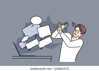 Stressed man overwhelmed with online negative comments and messages on computer. Unhappy guy struggle with hate and bullying on internet. Abuse on social media. Vector illustration. 