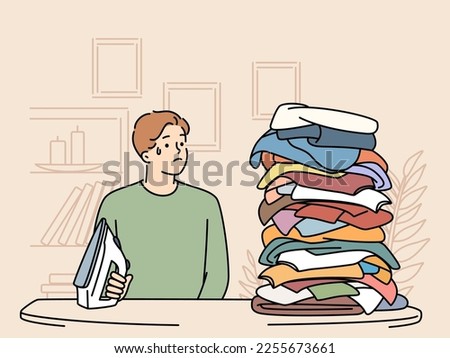 Stressed young man look at clothes pile for ironing. Unhappy guy distressed with stack of laundry to be ironed. Household chores. Vector illustration. 