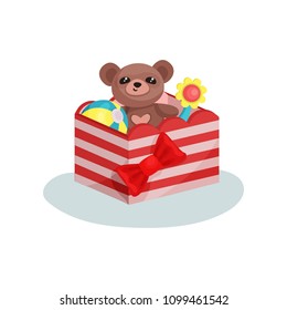 Striped box with red bow full of children toys. Cute teddy bear, inflatable ball and flower. Flat vector icon