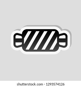 Striped candy icon. Tasty caramel. Sticker style with white border and simple shadow on gray background